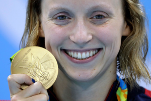 FILE - In this Aug. 12, 2016, file photo, United States' Katie Ledecky shows off her gold medal in the women's 800-meter freestyle. Photo / AP.