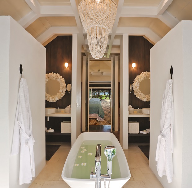 Bure bathroom looking out to bedroom and beach.