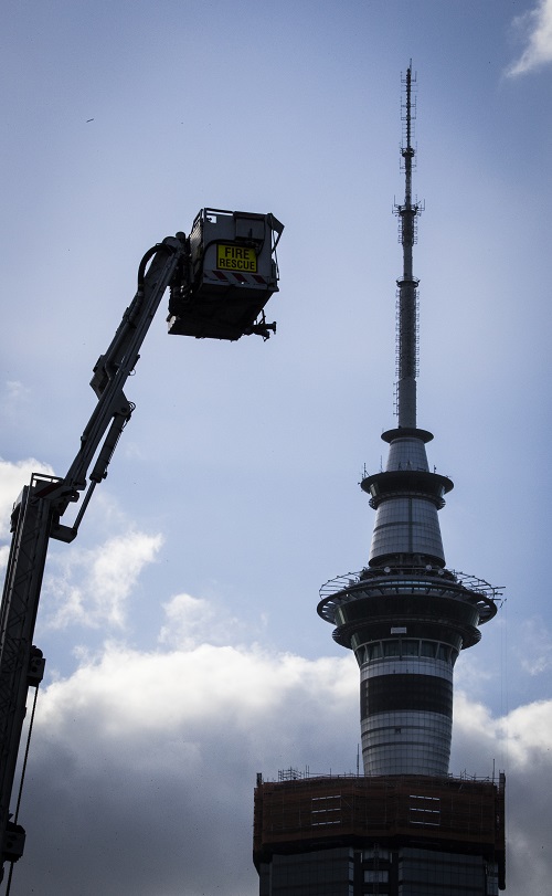 Emergency services respond to the fire at the top of the 21-storey high rise. Photo / Greg Bowker
