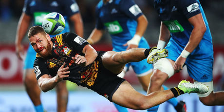 A bloodied Tawera Kerr-Barlow of the Chiefs passes. Photo / Getty