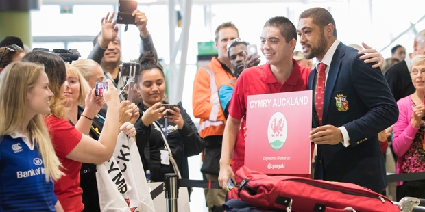 Taulupe Faletau poses at Auckland Airport yesterday with one of the thousands of Lions fans already in New Zealand. Photo / Greg Bowker