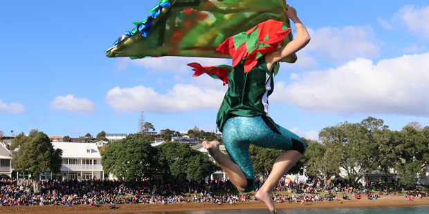 Laura Stevenson of Paihia jumps from Russell wharf in a costume inspired by the kakariki, a parakeet reintroduced to the Bay of Islands. Laura and husband Ryan won this year's crowd favourite title.