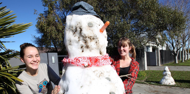 (L-R) Ruby and Erica McKnight spent yesterday afternoon building 'Frosty the Snowman' outside their Meeanee home after fetching snow from the Napier Taupo Rd. Photo/Duncan Brown