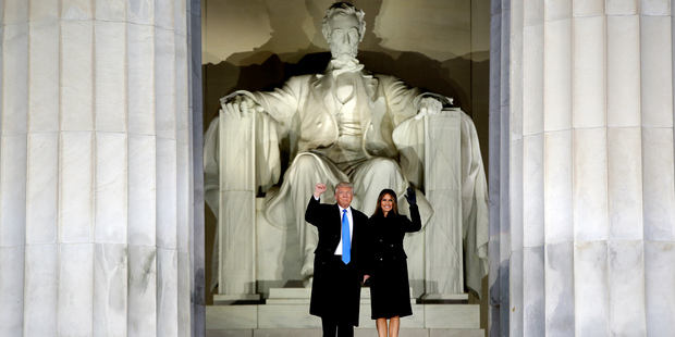 President-elect Donald Trump and his wife Melania Trump waves as they arrive at a pre-Inaugural "Make America Great Again! Welcome Celebration" at the Lincoln Memorial in Washington, Thursda