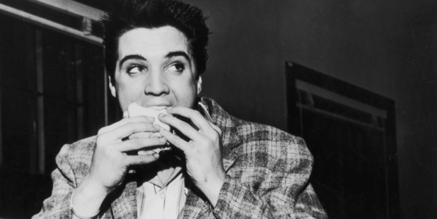 American singer and actor Elvis Presley in 1958 eating one of his favourite sandwiches in Memphis, Tennessee. Photo / Getty 