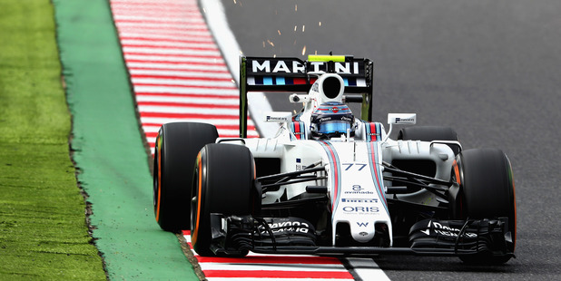 Sparks fly behind Valtteri Bottas' Williams in Japan. Photo / Getty Images