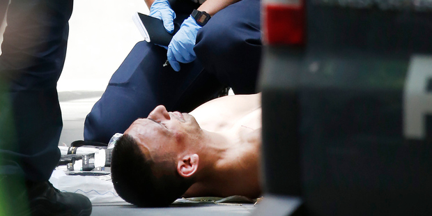 The driver of the car was shot in the arm and subdued before being taken into custody and was last night under police guard in hospital. Photo / News Limited