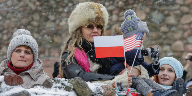 People watch the official welcoming ceremony for the US troops in Zagan. Photo / AP