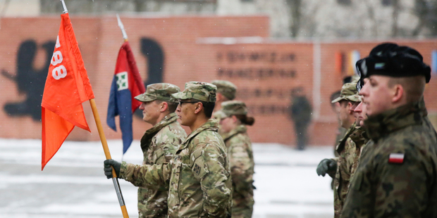 Polish and US units display their colours at the Zagan parade. Photo / AP