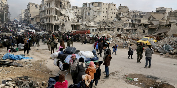 Ludy Chakhto finds it hard to look at images like these. ALEPPO, SYRIA - People wait at a crossing point at Amiriyah district of Aleppo, Syria on December 16, 2016.
