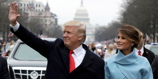 Donald Trump waves to supporters as he walks the parade route with first lady Melania Trump after being sworn in at the 58th Presidential Inauguration. Photo / Getty Images