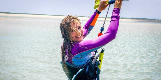 Terrifying footage shows a shark swim just metres away from unsuspecting kitesurfer