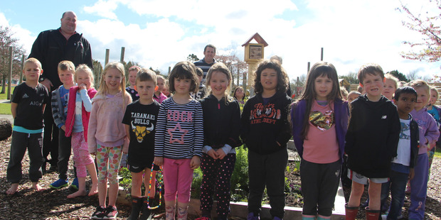 Dan Harris from New World Stratford with some of the youngsters who will enjoy seeing the bees visit their school gardens.