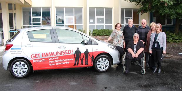 Ethel Gray Charitable Trust trustees Mary Stanley, Doug Hutchinson, Shirley Hazlewood, Barrie Smith, Barbara Williams with Melanie Hurliman, co-ordinator for vaccinations at the TDHB and a co-opted member of the trust along with the newly signwritten car.