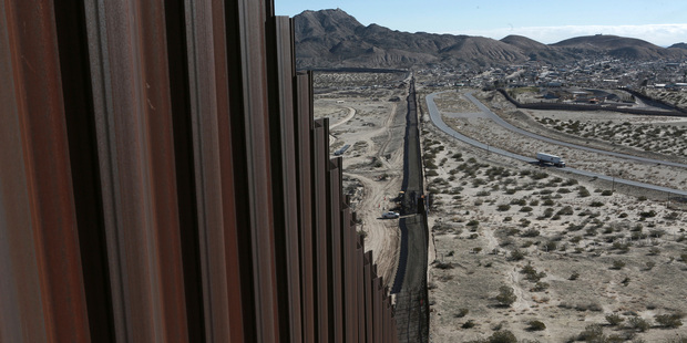 A truck drives near the Mexico-US border fence, on the Mexican side, separating the towns of Anapra, Mexico and Sunland Park, New Mexico. Photo / AP