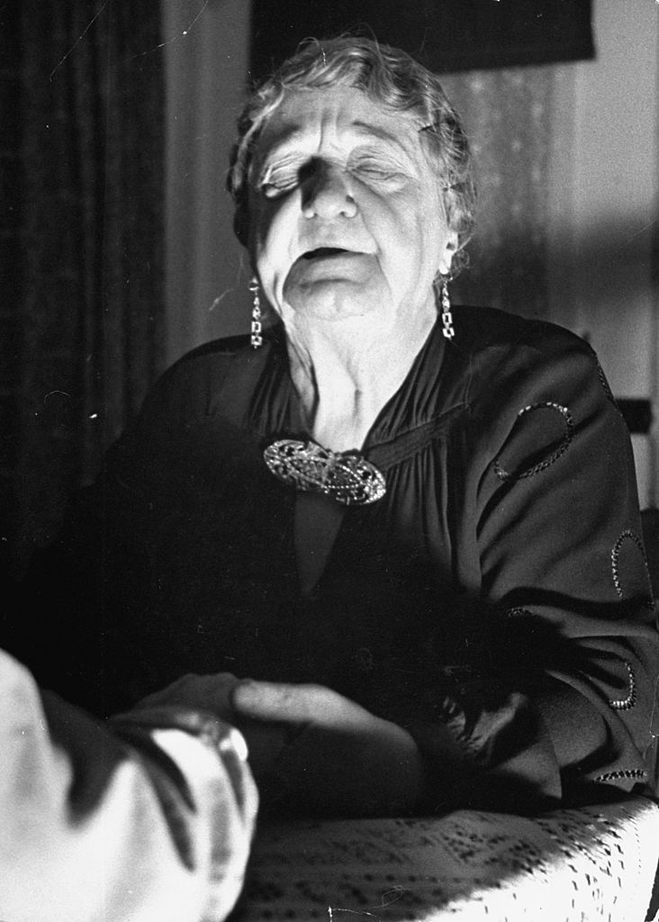 Spiritualist Maggi Waite under a trance with a Spanish girl at Lily Dale in the 1930s. Photo / Getty Images