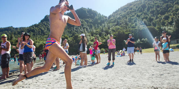 Swim Rotorua's David Boles sprinting across the beach at Blue Lake at the end of the Hinemoa Swim. PHOTO/ BEN FRASER 