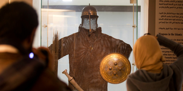 Visitors view a warrior costume, helmet and quiver dated to the 15th-16th century Mamluk period, during the re-opening of the Museum of Islamic Art in Cairo. Photo / AP