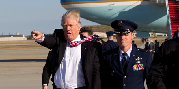 President Donald Trump walks on the tarmac as he waves to the crowd upon his arrival at Andrews Air Force Base. Photo / AP
