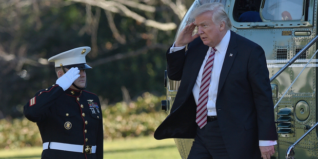 President Donald Trump salutes walks off of Marine One on the South Lawn of the White House in Washington. Photo / Getty Images