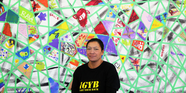 Stormie Hunter-Rogan from Nga Tai O Te Awa standing next to the paint a patch five ways to well-being art display. Photo/ Stuart Munro