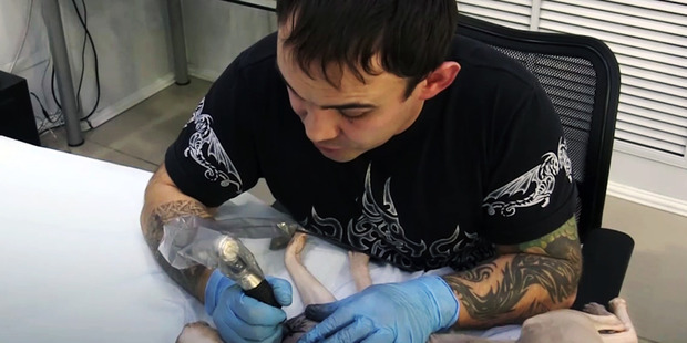 Aleksandr had to put the cat under anaesthetic so he could stand the pain of the ink needle. Photo / Australscope