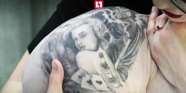  Aleksandr's wife with the tattooed cat. Photo / Australscope