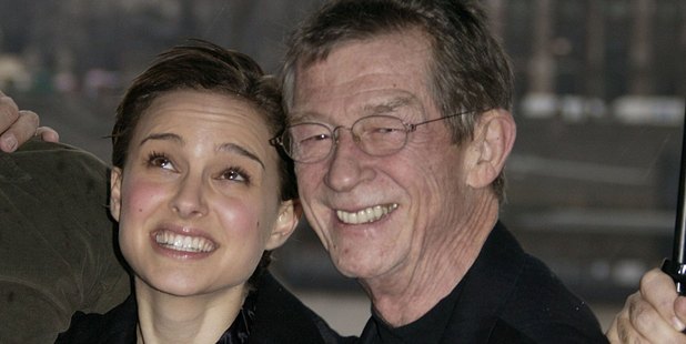 Natalie Portman and John Hurt shelter from the rain together. Photo / Getty Images
