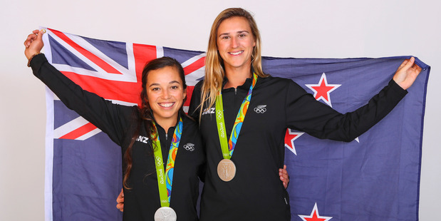 Molly Meech and Alex Maloney pose for a portrait with their Olympic Sailing silver medals. Photo / Getty Images