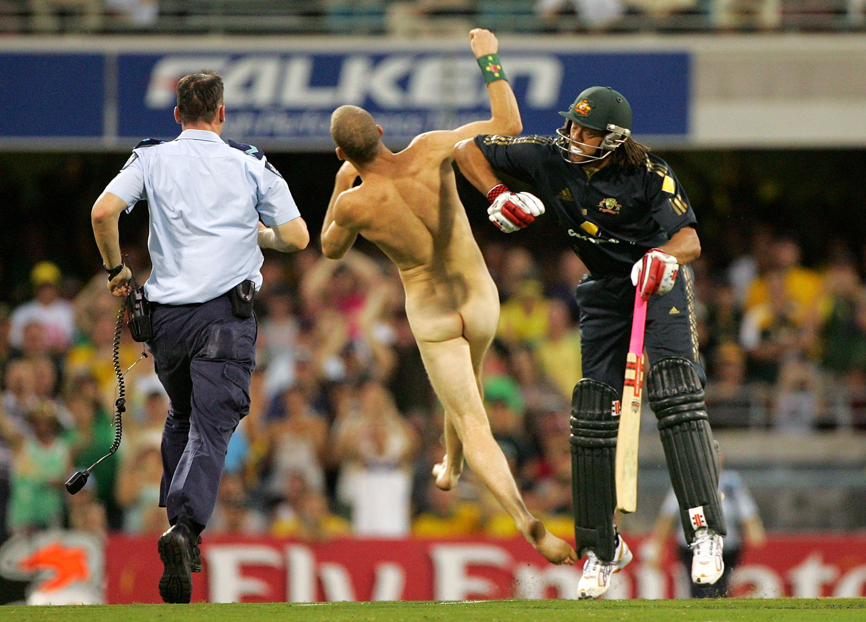 Andrew Symonds of Australia knocks over a streaker. Photo / Getty