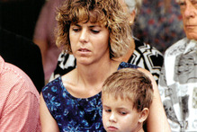Kim Van De Wetering with her son at the one year anniversary memorial service for the victims of the Raurimu massacre 09 February 1998 New Zealand Herald Photograph by Brendon O'Hagan