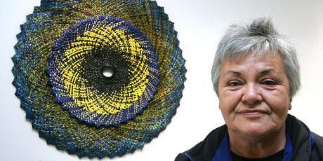 WEAVING A STORY: Master weaver and teacher Bibbins Tangitu with one of her porohita (circle) creations. Photo/supplied