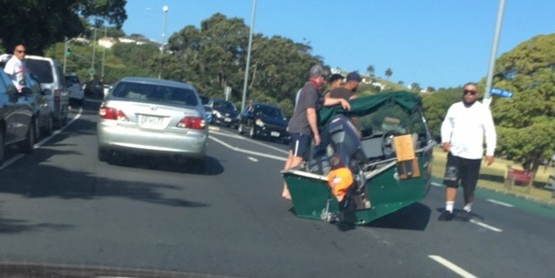 A boat fell off a trailer on Tamaki Drive in Auckland this evening. Photo / Courney Agate