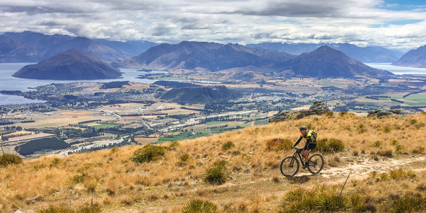 Michael Brown rides in the high country above Lakes Wanaka and Hawea during stage six a 66km journey that climbed 2000m during the 7 day Pioneer Mountain Bike ride. Photo / Greg Bowker