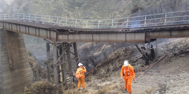 KiwiRail staff inspect fire damage on the Midland Line to the West Coast. Photo / Supplied