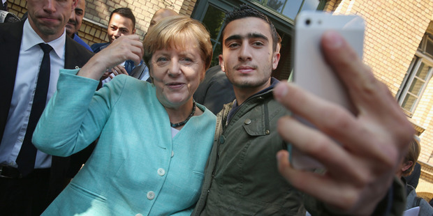 German Chancellor Angela Merkel poses for a selfie with Syrian refugee Anas Modamani. The selfie is the centre of a lawsuit Modamani has launched against Facebook. Photo / Getty