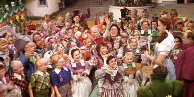 A crowd of Munchkins from a scene in The Wizard of Oz. Photo/MGM