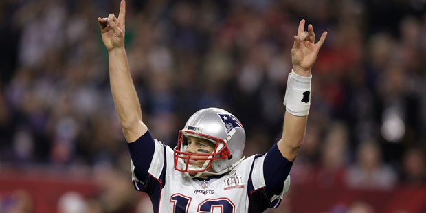 New England Patriots' Tom Brady raises his arms after scoring a touchdown during overtime of the NFL Super Bowl 51 football game. Photo / AP.