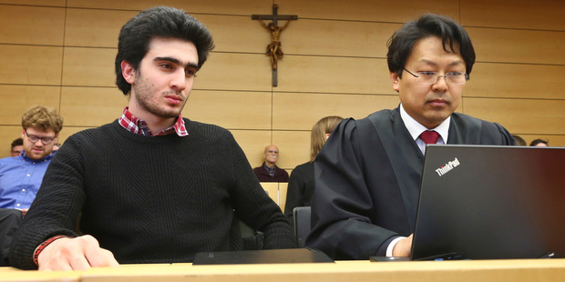 Anas Modamani, left, sits next to his lawyer Jun Chan-jo at the regional court in Wuerzburg, Germany. Photo / AP