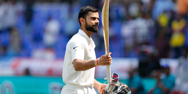 India's captain Virat Kohli raises his bat to acknowledge the applause from the crowd as he leaves the ground after losing his wicket. Photo / Aijaz Rahi