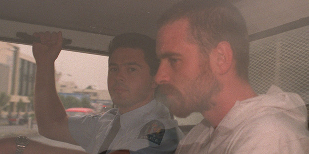 Stephen Anderson is driven from the Hamilton District Court in a police van in 1997. Photo / NZ Herald