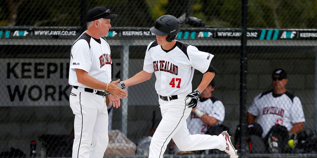 Coach Mark Sorenson congratulates star infielder Cole Evans on the way to New Zealand's Challenge Cup victory. Photo / Photosport