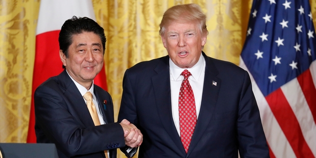 Was Shinzo Abe ready for Donald Trump's special style of shaking hands? Photo / AP