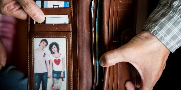 The wallet of Hui Yun Tu, 22, was recovered from the rubble of the CTV building. It still contains New Zealand cash, bank cards and a photo of Hui Yun with her boyfriend. Photo / Mike Scott
