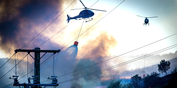 helicopters fight the blaze on the Port Hills Christchurch. Photo / Christchurch Star / Martin Hunter