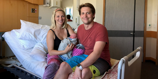 Jessica and Luke Thomas hold the newborn Thea, who arrived a week early. Photo / Supplied
