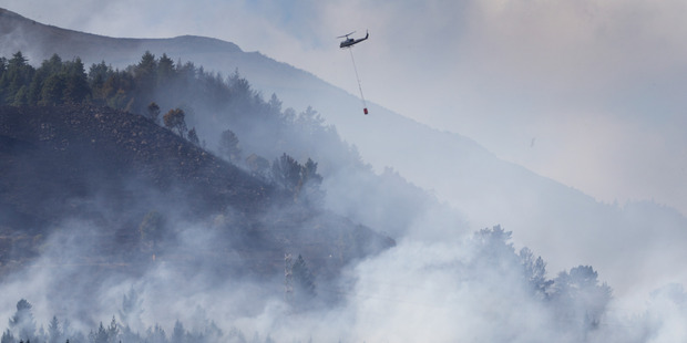 Crews had to pick their targets at the height of the blaze. Photo / Alan Gibson