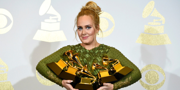 Adele poses in the press room with the awards for album of the year, song of the year, record of the year and best, best pop solo performance and best vocal album. Photo / AP