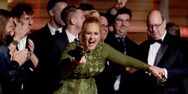 Loading Adele accepts the award for album of the year for '25' at the 59th annual Grammy Awards. Photo / AP