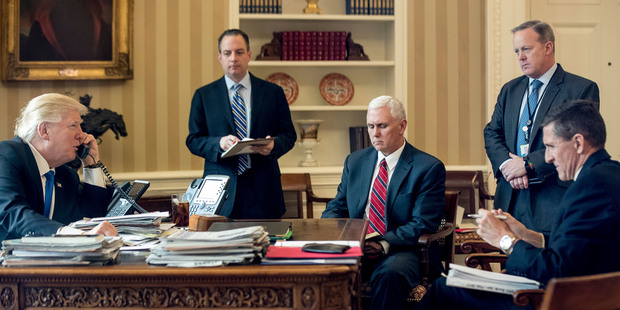 Trump accompanied by his staff, speaks to Putin on the phone. Photo / AP